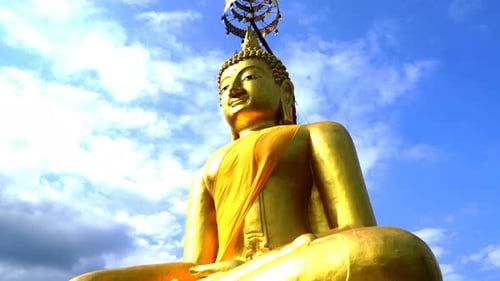 Golden Buddha Statue Under a Sunny Sky
