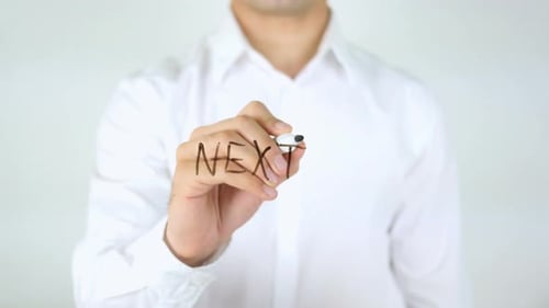 Man Writes 'Next' on Clear Surface