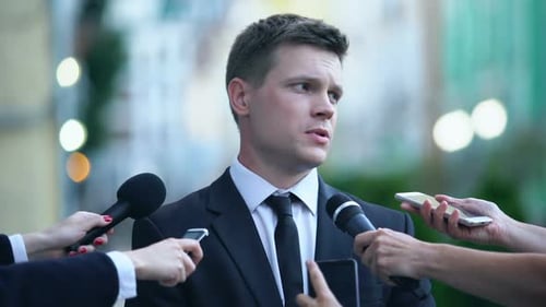 Young Man Gives Statement to Eager Reporters