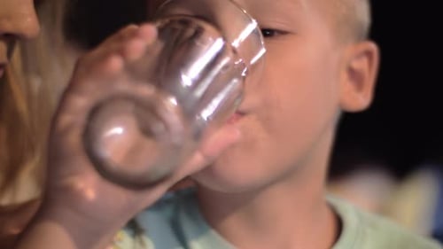 Child drinking water outdoor