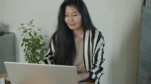 Woman Working on Laptop at Indoor Location