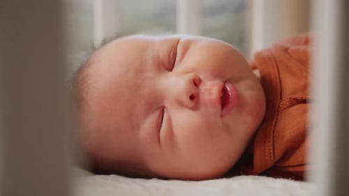 Cute Infant Relaxing in Crib