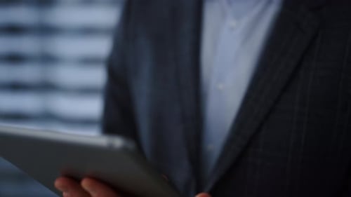 Tablet Computer in Business Man Hands Closeup
