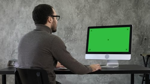Bearded young businessman woking on computer, Green Screen