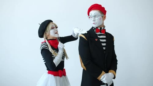 Female Mime Attacks Man in Studio Performance