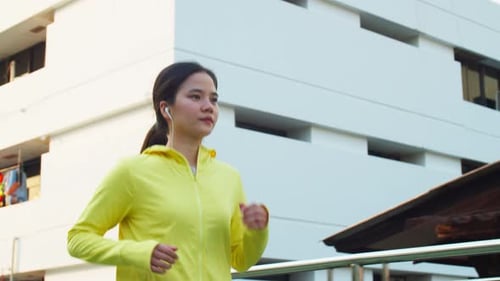 Asian female running on street view beautiful sunset, Athlete sport running workout concept.