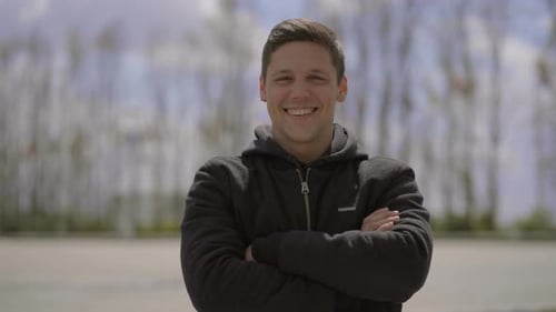Happy Young Man Looking at Camera on Street