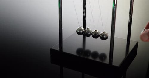 Newton's Cradle Demonstrates Conservation of Momentum