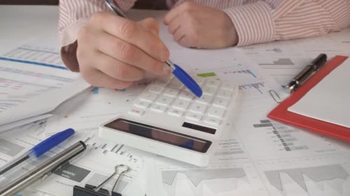 Male Hands Consider the Correctness of the Financial Statement in the Office