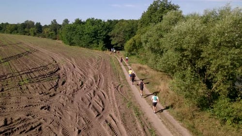 Aerial Shot of People in Trail Running Marathon in a Countryside Field Road, Slow Motion 60 Fps