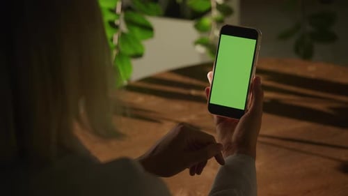 Handheld Close Up of a Woman Holding Vertical Smart Phone with Green Screen Chroma Key