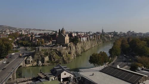 Drone is Flying Over the Streets of Tbilisi and River Kura Buildings on Cliff