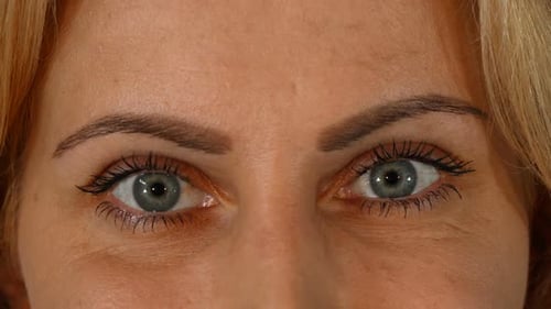 Beautiful Blue Eyes of a Mature Woman Looking To the Camera