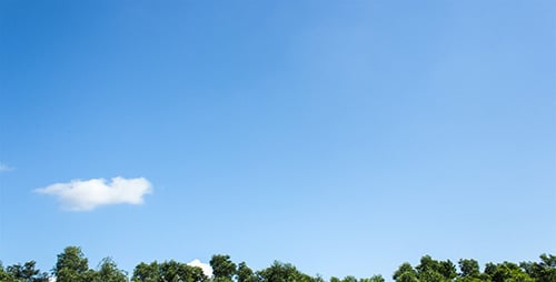 Clouds Drifting Across Sunny Blue Sky Time-lapse