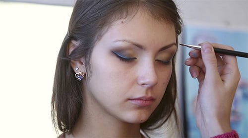 Young Woman Receiving Professional Makeup Application