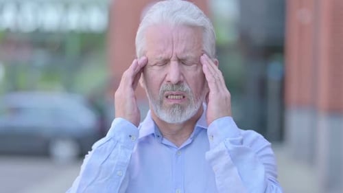 Senior Man Experiencing Headache Outdoors