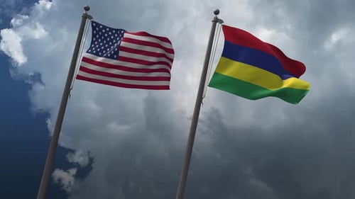 United States and Mauritius Flags Waving Under Cloudy Sky