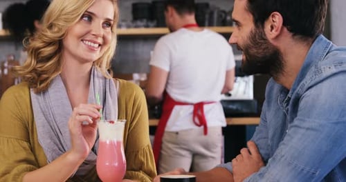 Couple Talking and Smiling in Cafe