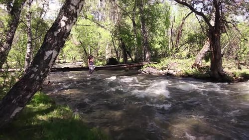 Ein schönes Mädchen sitzt auf einer Brücke unter der Brücke ein Fluss fließt
