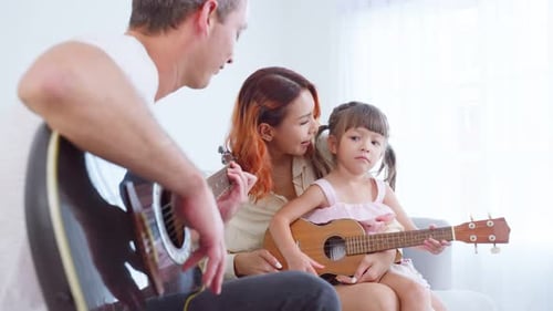 Family Plays Guitar and Ukulele Together at Home