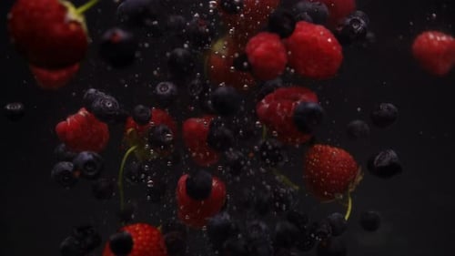 Fresh Berries Falling and Floating Against Dark Background