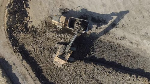 Excavator Fills Dump Truck With Soil, Birds Eye View