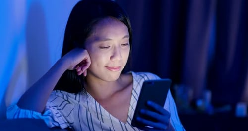 Woman Using Cell Phone At Night