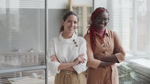 Portrait of Two Young Women in Modern Office