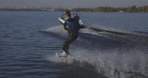 Young Man Wakeboarding on River