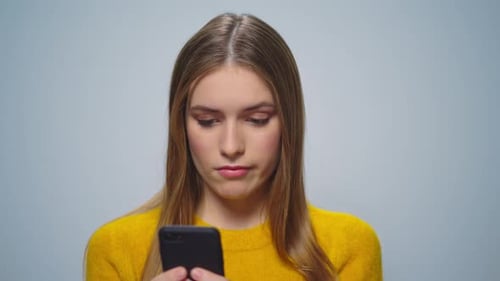 Woman Reacts with Shock to Smartphone News