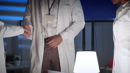 Close Up of Specialists' Hands Giving Greetings To Each Other in Lab