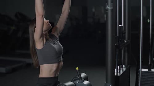Female in the Gym Lifting Blocks on Rack Machine Strength Training on Block Device and Gym Equipment