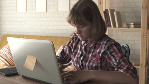 Young Adult Working on Laptop at Home