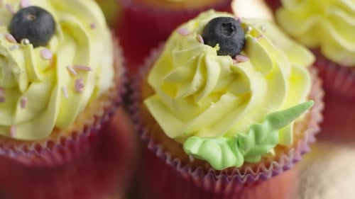Delicious Cupcakes with Yellow Frosting and Blueberries