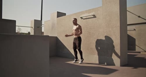 Sportsman Doing Jumping Jacks on Sports Ground