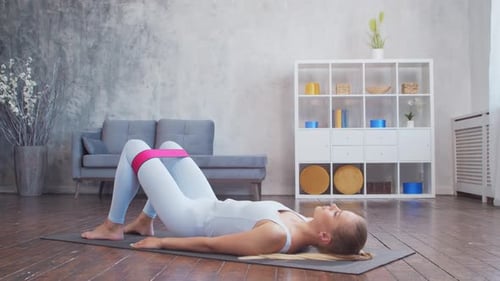 Woman Doing Glute Bridge Exercise with Resistance Band