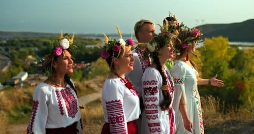 Adults Singing in Traditional Dress in Rural Setting
