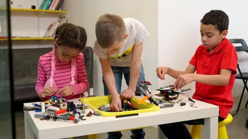Kids Using Building Kit To Create Toys