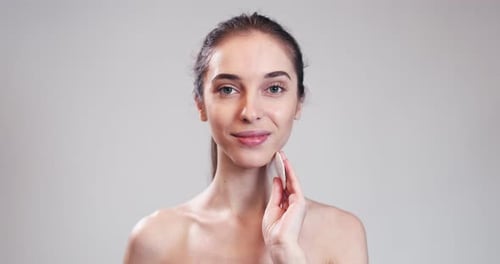 Girl Cleaning Her Face with Cotton Swab Pad