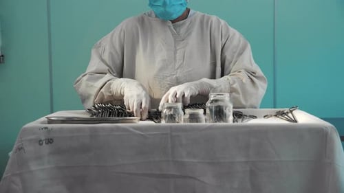 Surgeon Preparing Surgical Instruments in Operating Room