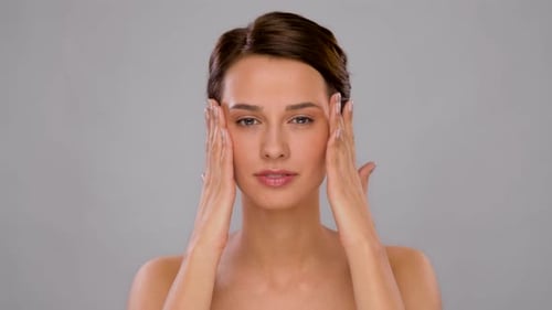 Woman Massaging Cream Into Her Face