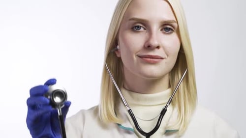 Blonde Doctor Holding Stethoscope Head Close Up
