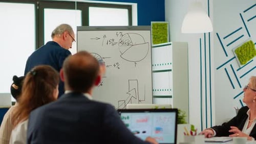 Business Colleagues Discussing Charts and Data in Office