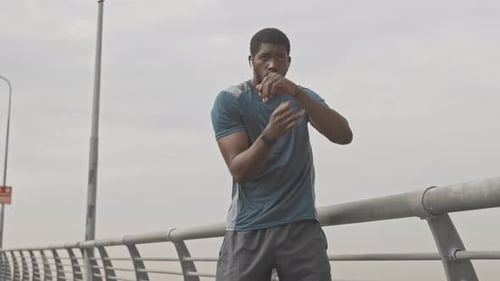 Man Practices Boxing Outdoors During Daytime