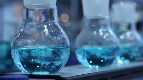 Blue Liquid Being Stirred in Glass Beaker