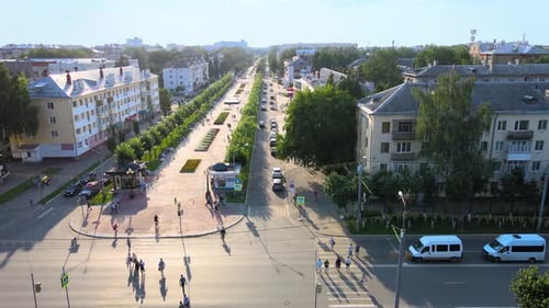 Drone footage of pedestrian scramble crosswalk with people crossing and traffic