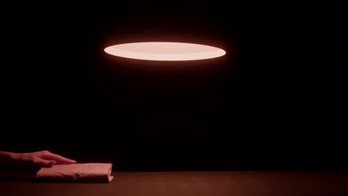 Wrapped Object on Desk in Dark Room