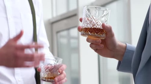 People Toasting Whiskey at Business Meeting