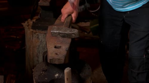 Blacksmith Shaping Hot Metal on Anvil with Hammer