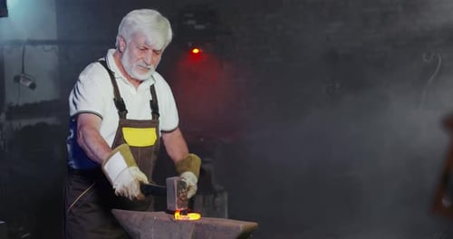Blacksmith Forging Metal on Anvil in Workshop